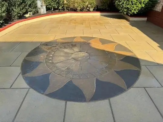 The same sunburst patio after cleaning, clean and bright